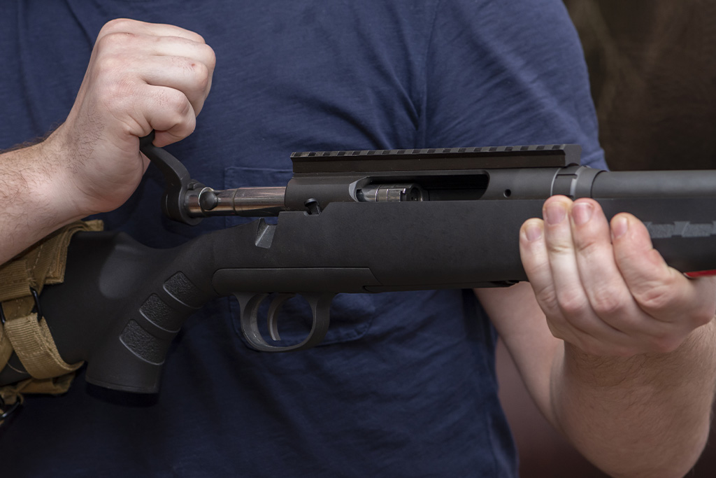 A Hunter Is Demonstrating the Bolt Mechanism on A Rifle